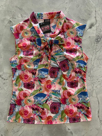 a flat lay of the front of the watercolor floral bow top