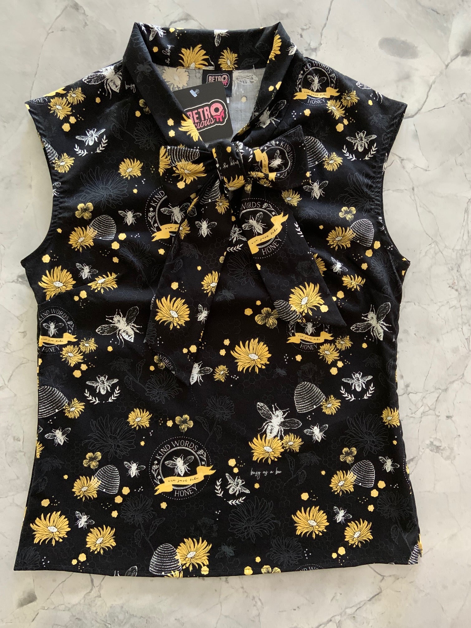 a flat lay of our bee kind bow top