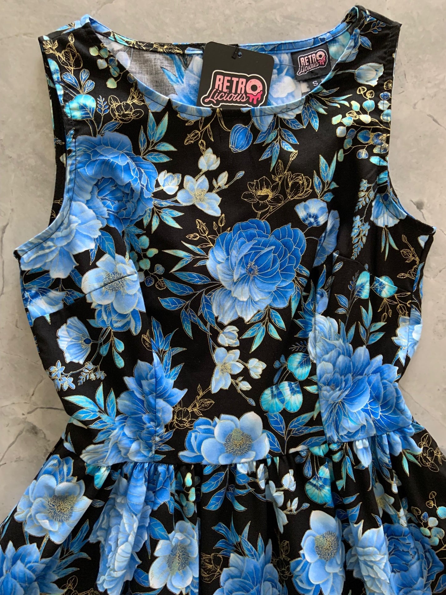 a flat lay of midnight floral vintage dress
