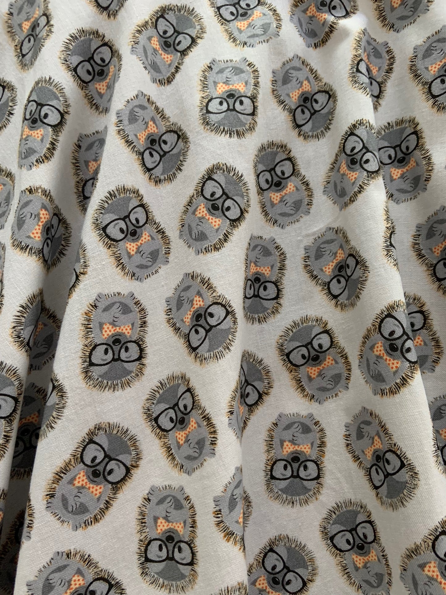 close up of fabric showing the hedgehogs in glasses in bow tie