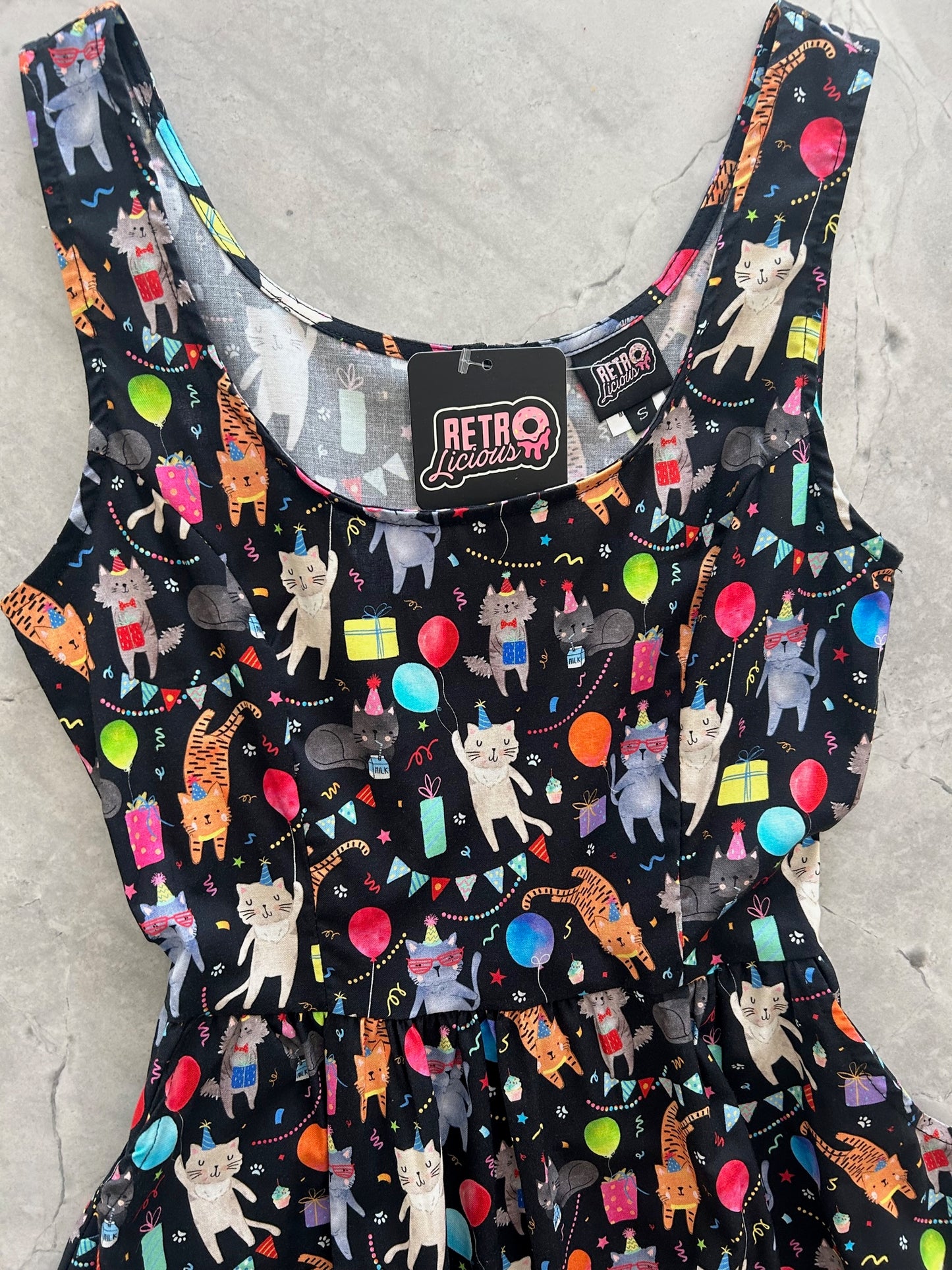 a close up of the bodice of the front of the party cats fit and flare dress