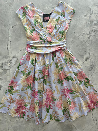 a flat lay of the front of the dragonfly metallic floral greta dress