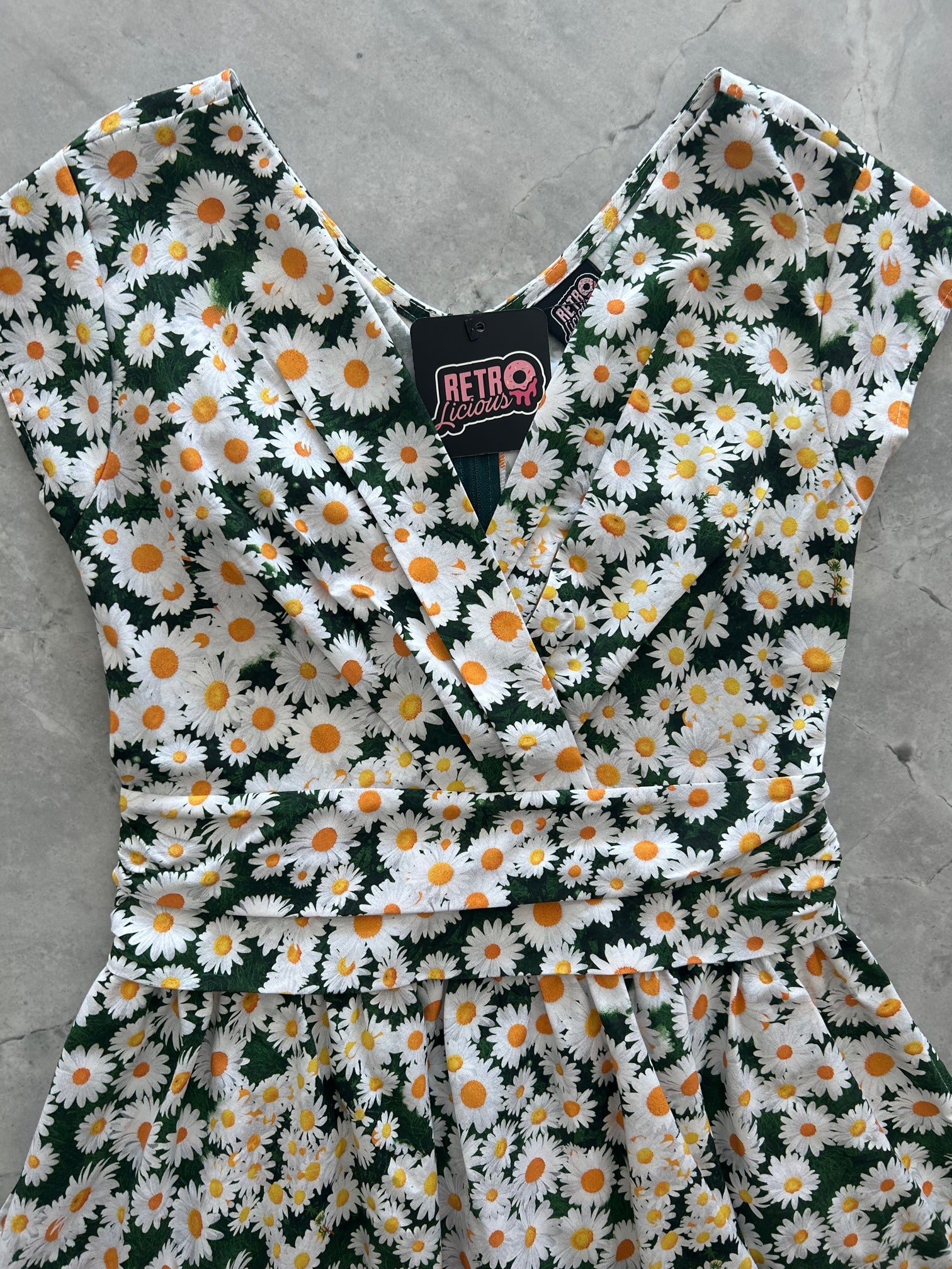a close up of the front of the bodice of the daisy greta dress