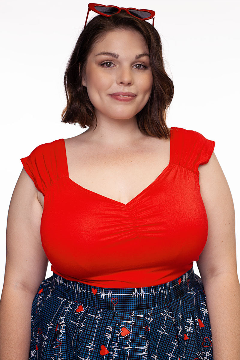 a plus size model wearing Isabel top in red