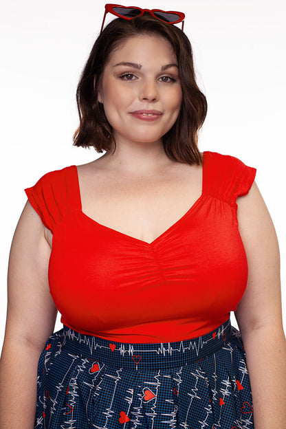 a plus size model wearing Isabel top in red