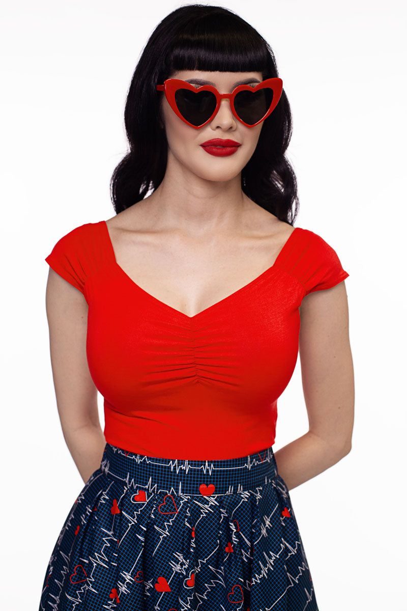 a close up image of a model wearing our Isabel top in red