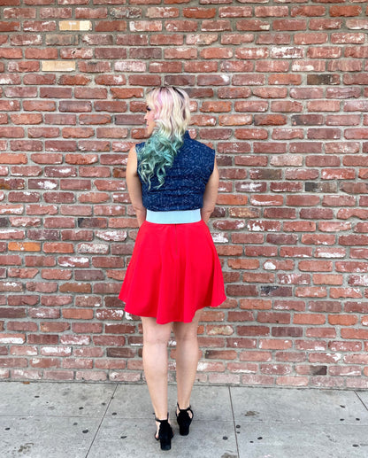 a full length of the back view of a model standing in front of a brick wall wearing our STEM bow top