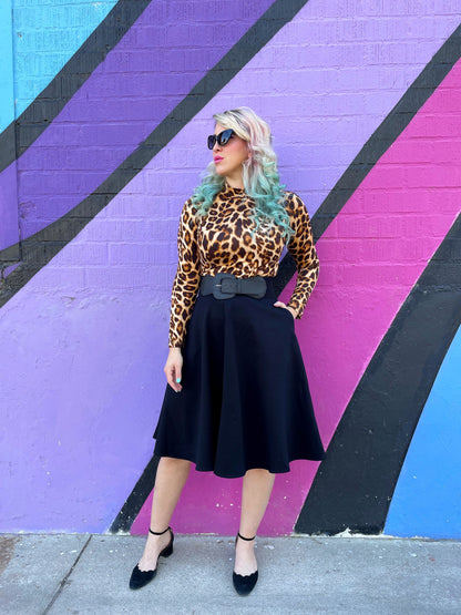 a full length of a model wearing our leopard mock neck top