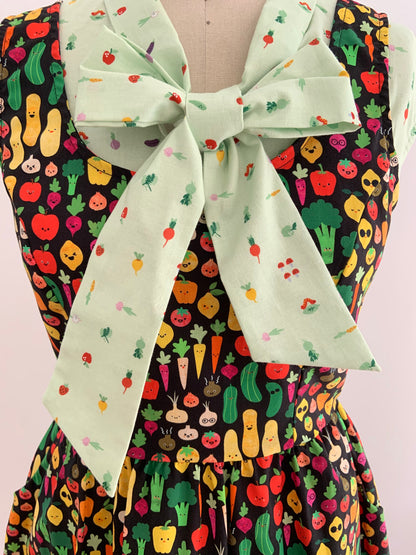 a close up of our veggies bow top shown underneath a dress