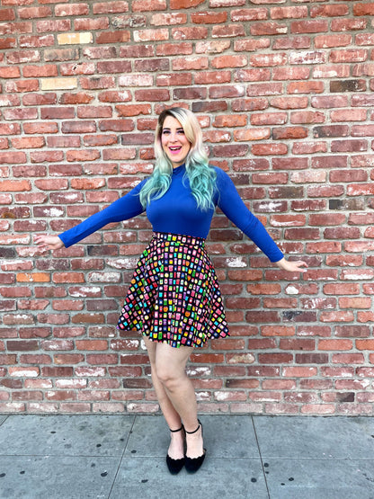 a model standing in front of a brick wall wearing that's my jam skater skirt