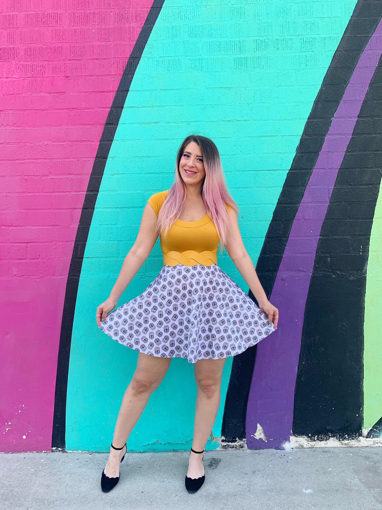 a model standing in front of a colorful painted wall wearing the Hedgehog Skater Skirt 