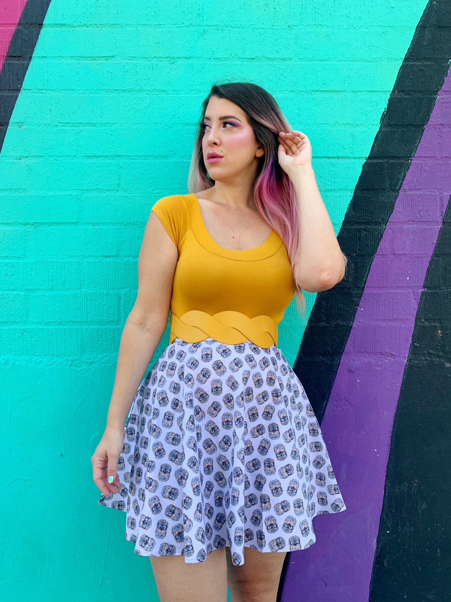 a model standing in front of a colorful painted wall wearing the Hedgehog Skater Skirt  