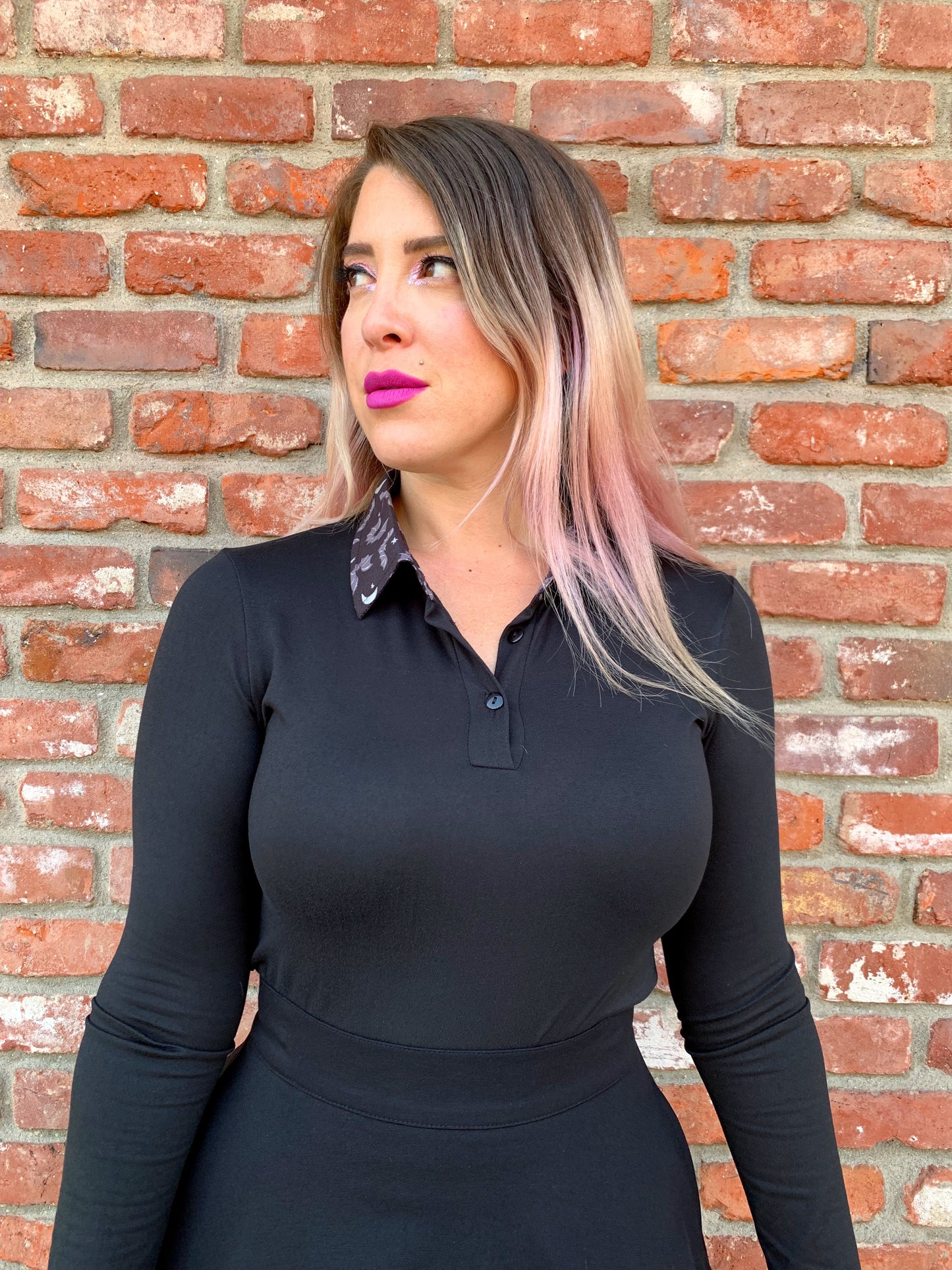 a close up of a model wearing our get batty long sleeve top with contrast collar