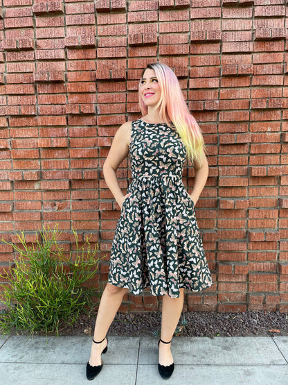 a full size image of a model standing in front a brick wall wearing the butterfly vintage dress