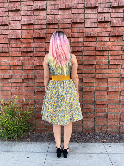 a full size image of a back side of a model standing in front of a brick wall wearing the cats in the fields twofer dress