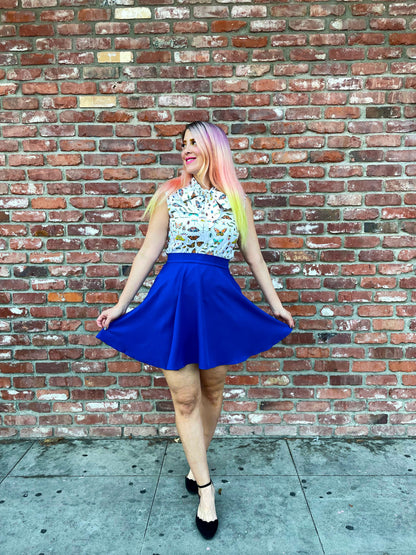 a model in front of brick wall wearing the royal blue skater skirt