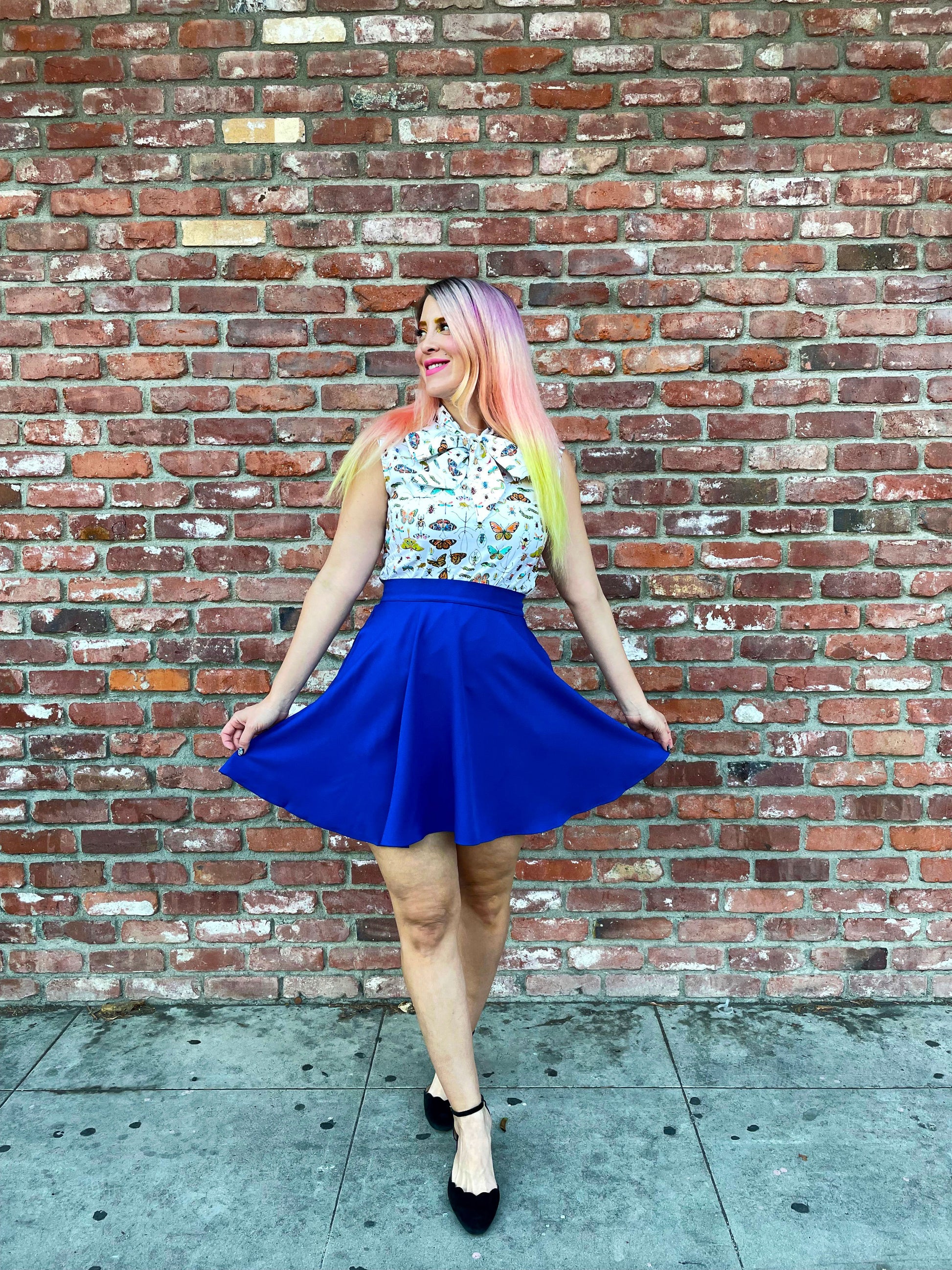 a model in front of brick wall wearing the royal blue skater skirt
