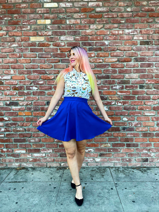 a model in front of brick wall wearing the royal blue skater skirt