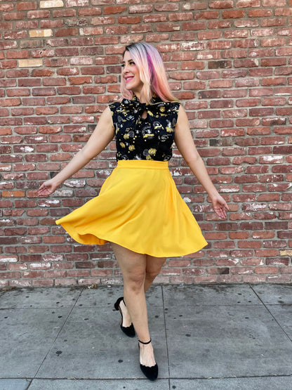 a model in front of brick wall wearing the marigold skater skirt