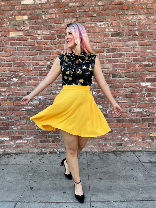 a model in front of brick wall wearing the marigold skater skirt