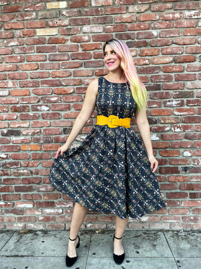 a full length image of a model standing in front of a brick wall wearing the Rabbit Midi dress