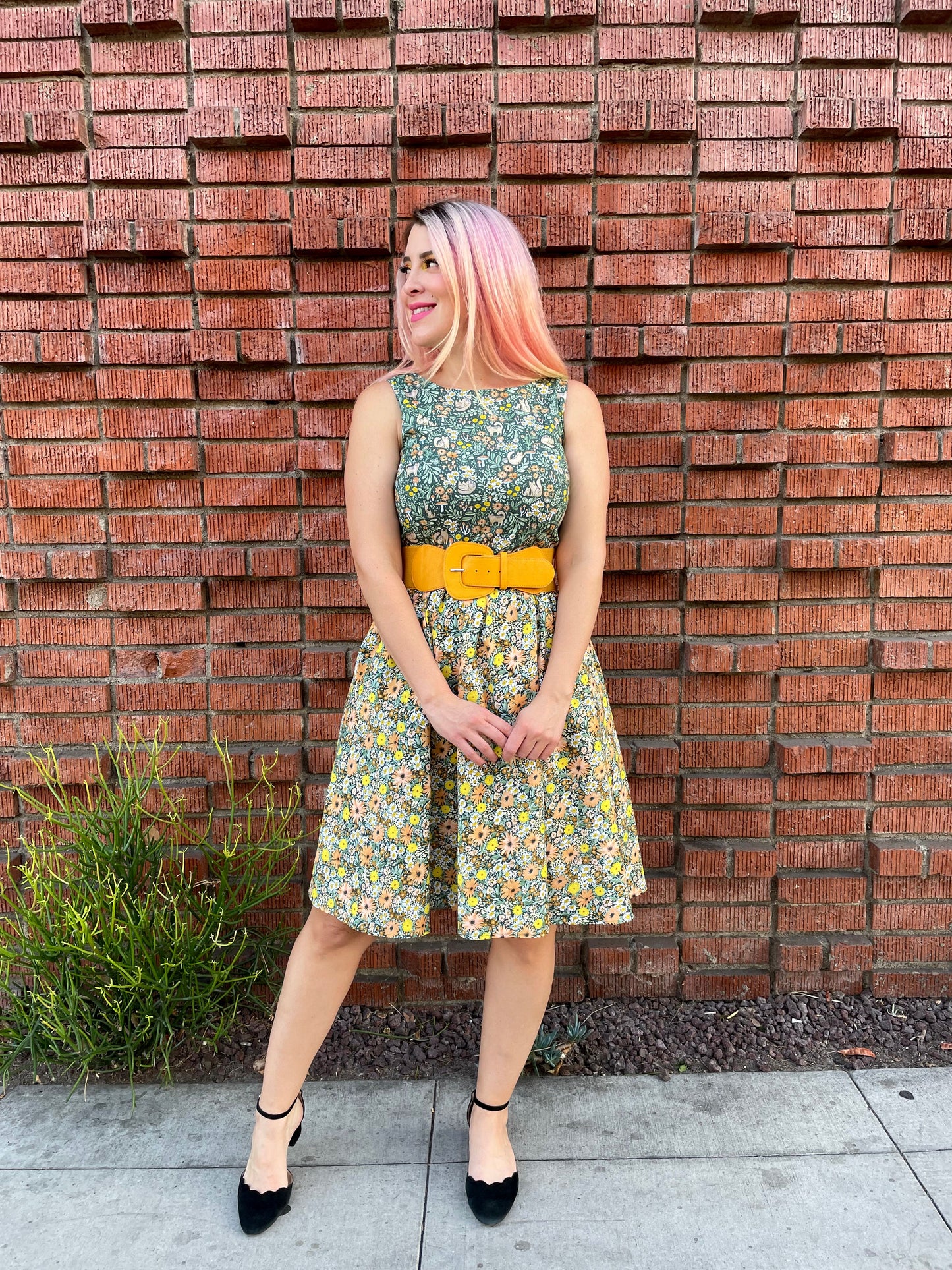 a full size image of a model standing in front of a brick wall wearing the cats in the fields twofer dress