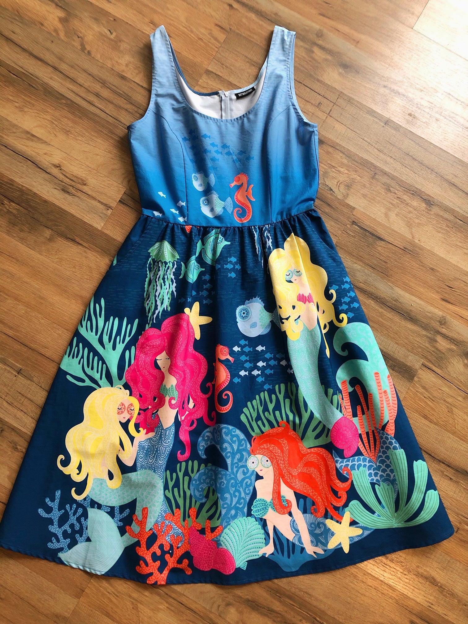 a flat lay of mermaid lagoon dress