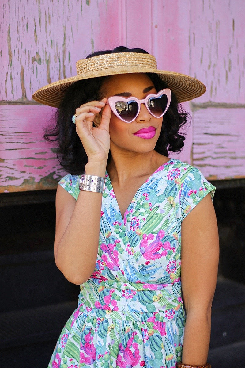 model wearing pink heart sunglasses
