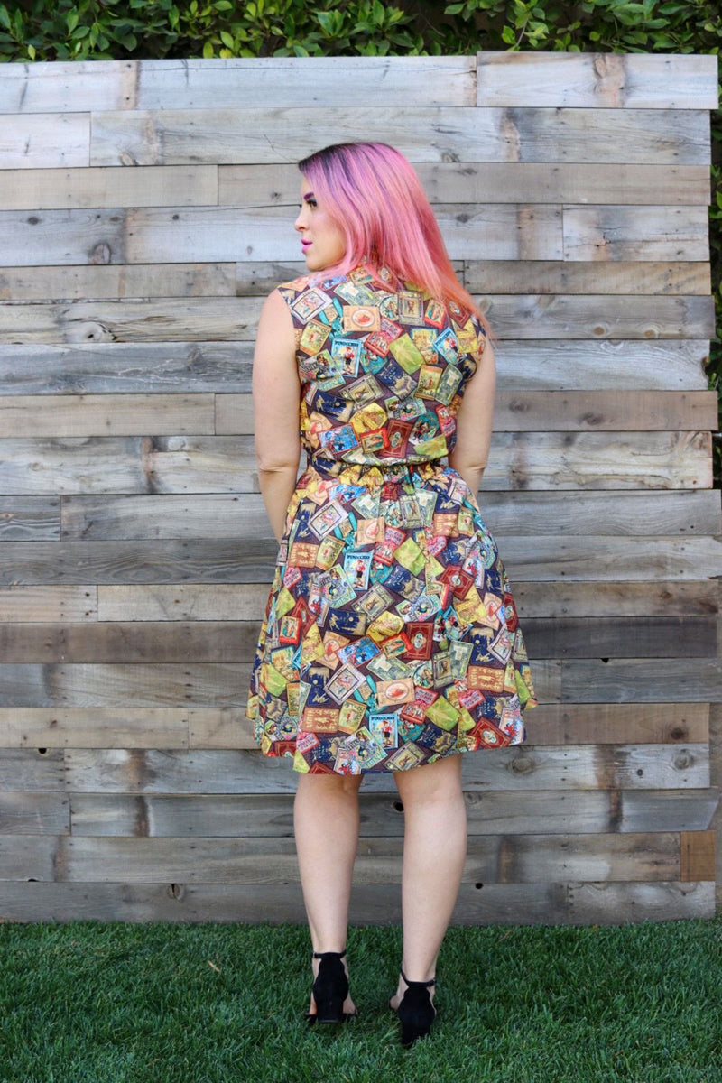a back view of model standing on grass in front of wood wall wearing the fairytale books a-line skirt